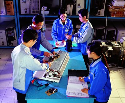 Team of technicians working on air conditioner repair